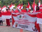 Pemkab Parimo Resmi Laksanakan Gernas Pembagian Bendera Merah Putih
